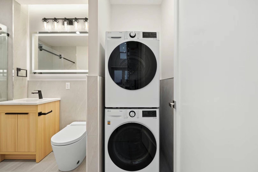 Bathroom with in-unit stacked washer and dryer at Hampton Condo